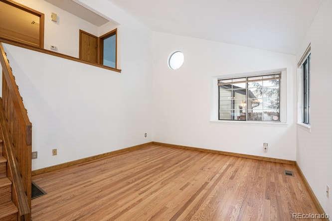 567 James Street Highlands Ranch, CO 80126 - Photo 3 of 17 a view of empty room with wooden floor and fan