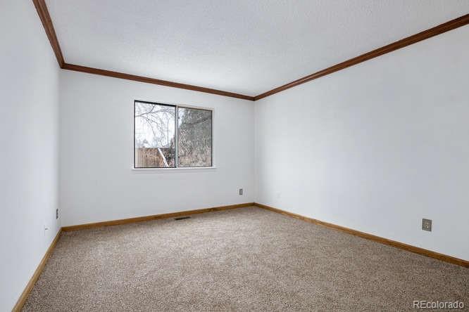 567 James Street Highlands Ranch, CO 80126 - Photo 10 of 17 an empty room with windows