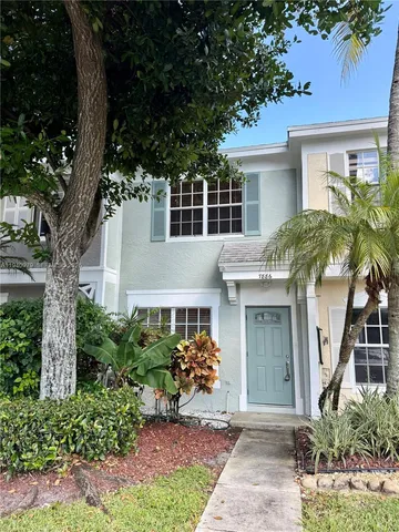 front view of a house with a tree
