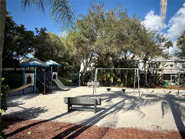 a view of a park with iron fence