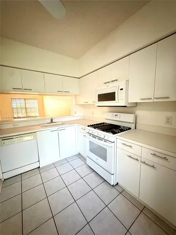 a kitchen with cabinets and appliances