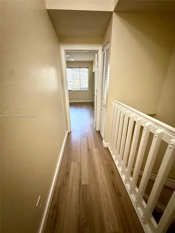 a view of a room with wooden floor and staircase