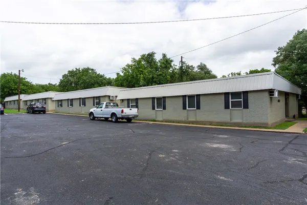 a front view of a house with a yard and balcony