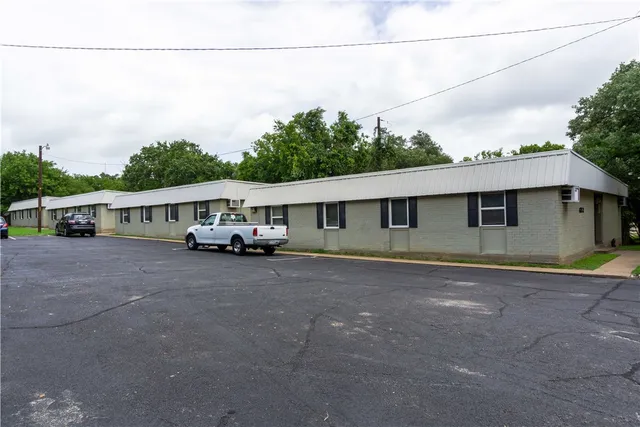 a front view of a house with a yard and balcony