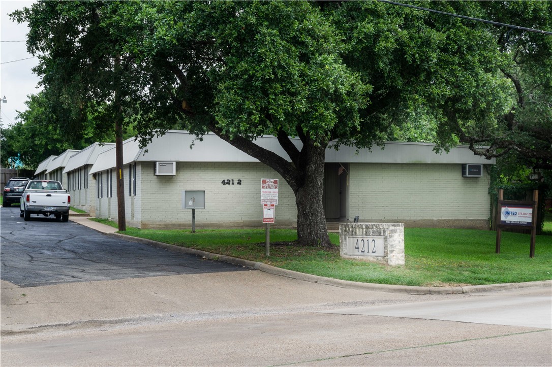 4212 Old College Road, Unit 12 Bryan, TX 77801 - Photo 4 of 5 a front view of a house with a yard and garage