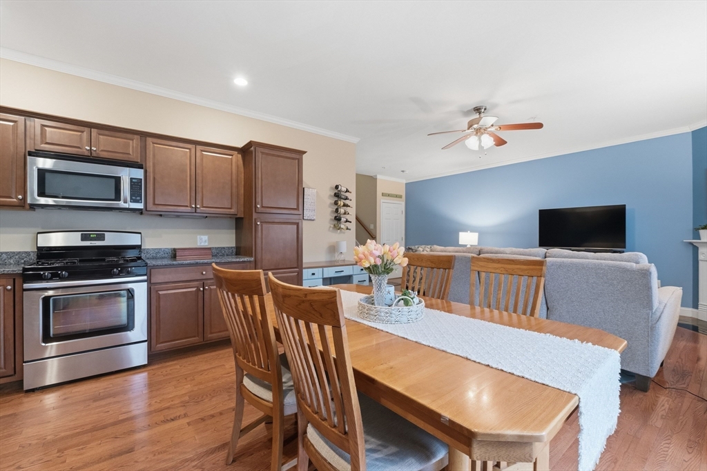 90 Rangeway Road, Unit 204 North Billerica, MA 01862 - Photo 13 of 41 a kitchen with stainless steel appliances a dining table and chairs