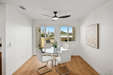 a dining room with wooden floor and chandelier