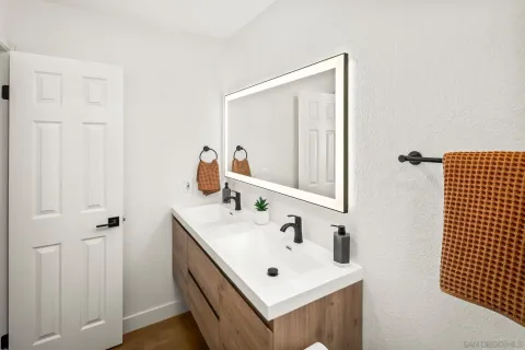 a bathroom with a sink vanity and mirror
