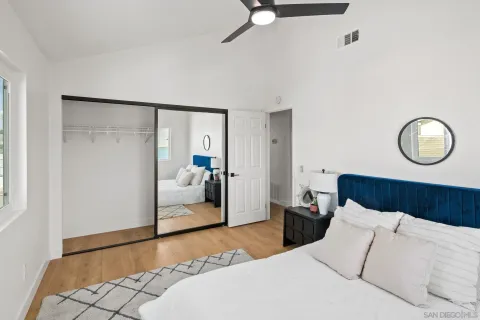 a bedroom with a bed and a mirror