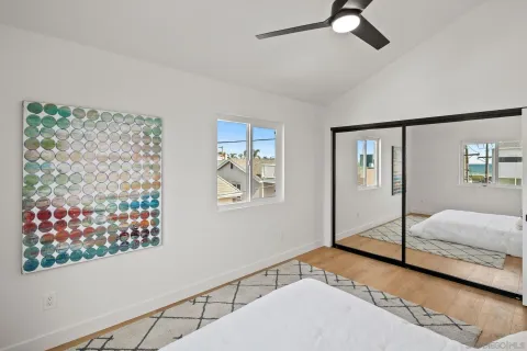a bedroom with natural light and wooden floor