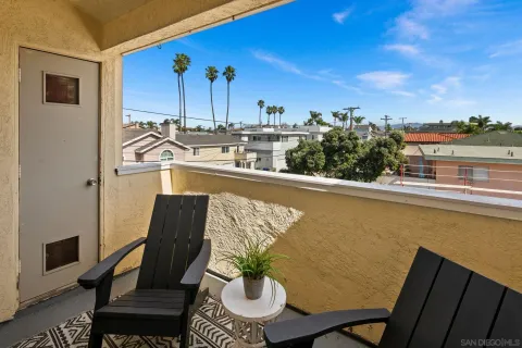 a view of a balcony with chairs and wooden floor