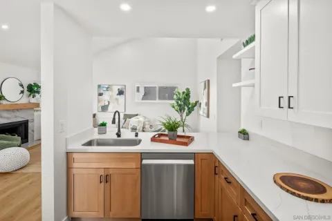 a kitchen with a sink a stove and cabinets