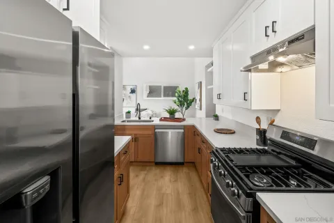 a kitchen with a sink stove and refrigerator