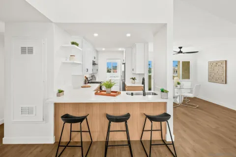 a kitchen with stainless steel appliances kitchen island a chandelier