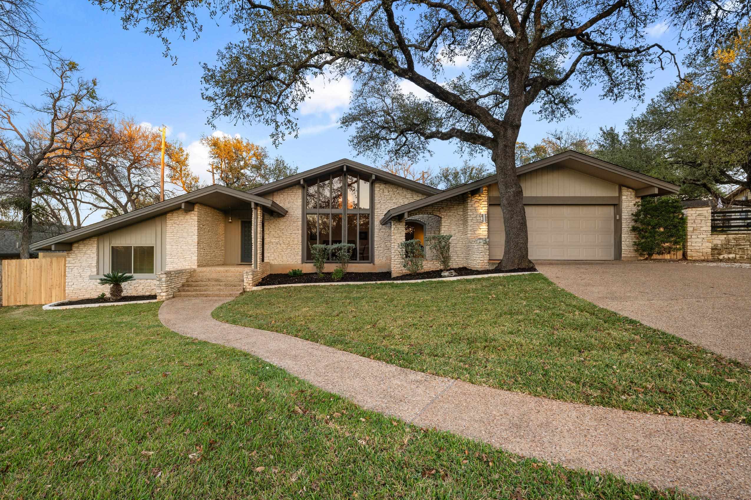 8805 Mountain Ridge Drive Austin, TX 78759 - Photo 1 of 30 a view of a yard in front of a house with large tree