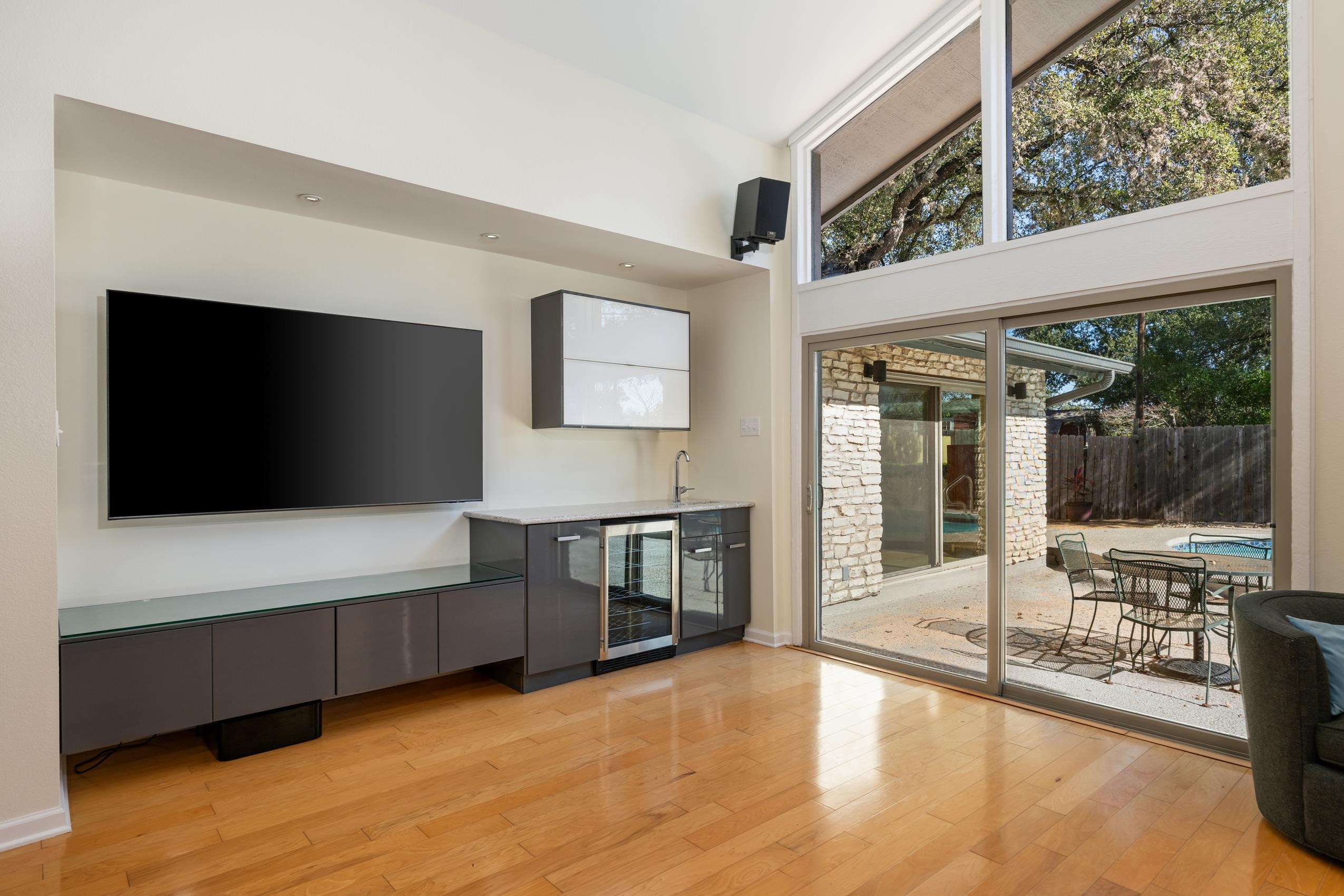 8805 Mountain Ridge Drive Austin, TX 78759 - Photo 13 of 30 a living room with furniture and a flat screen tv