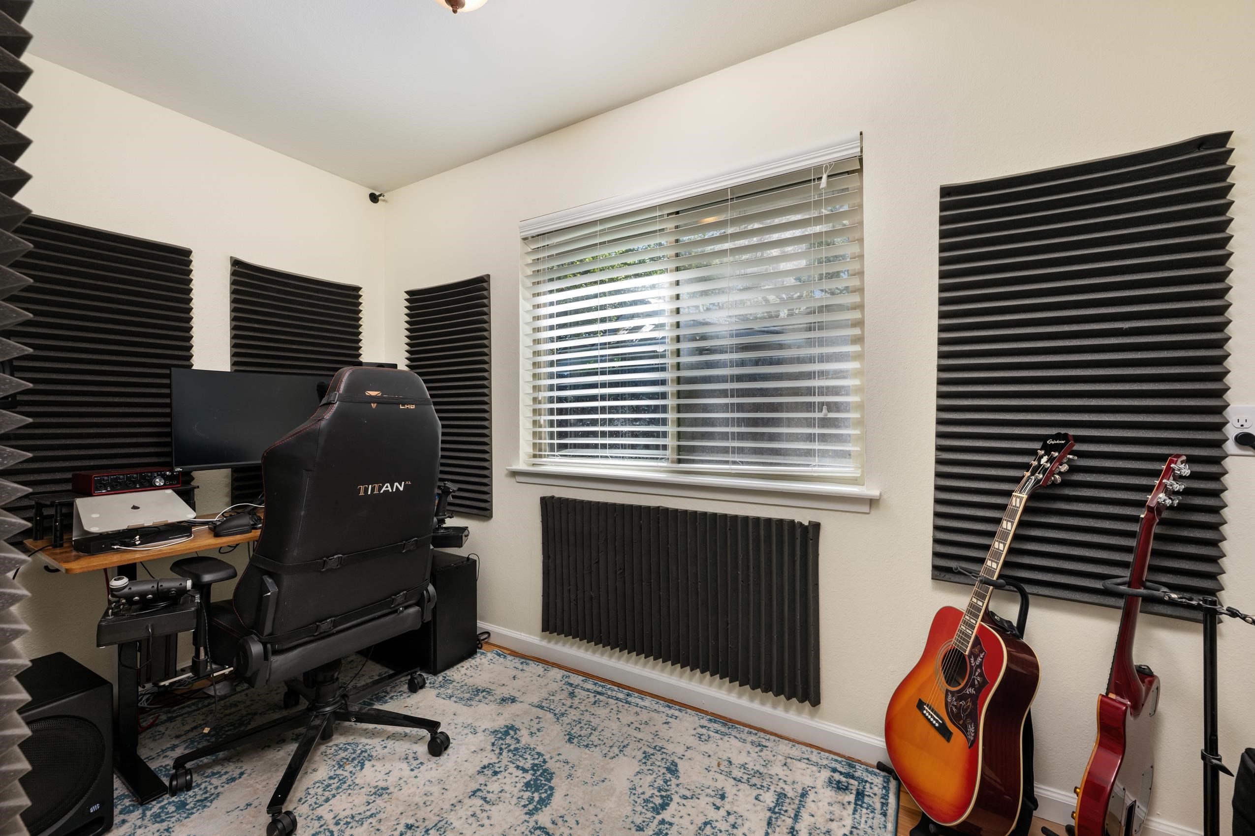 8805 Mountain Ridge Drive Austin, TX 78759 - Photo 14 of 30 a bedroom with furniture and a fireplace
