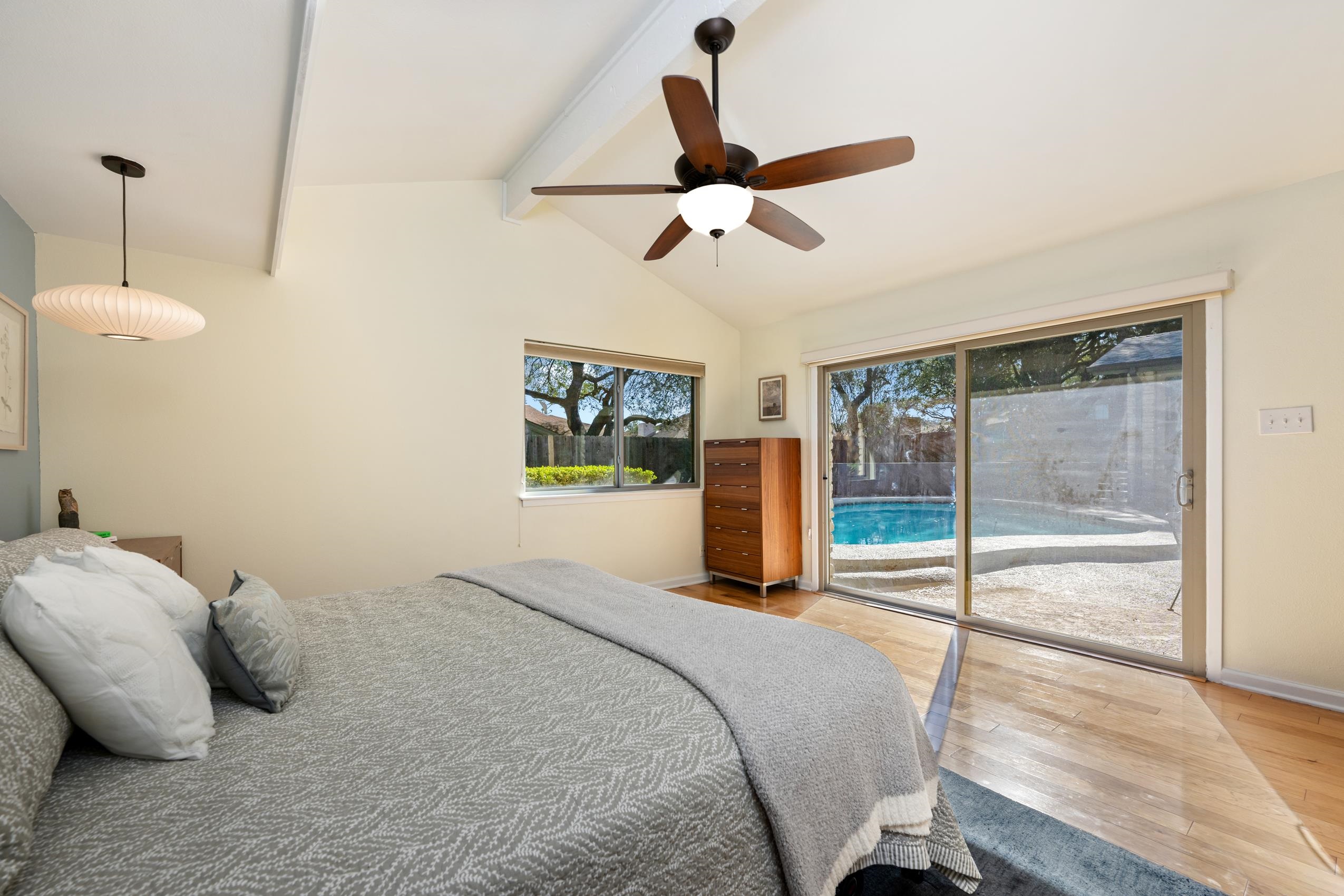 8805 Mountain Ridge Drive Austin, TX 78759 - Photo 16 of 30 a bedroom with a bed and ceiling fan