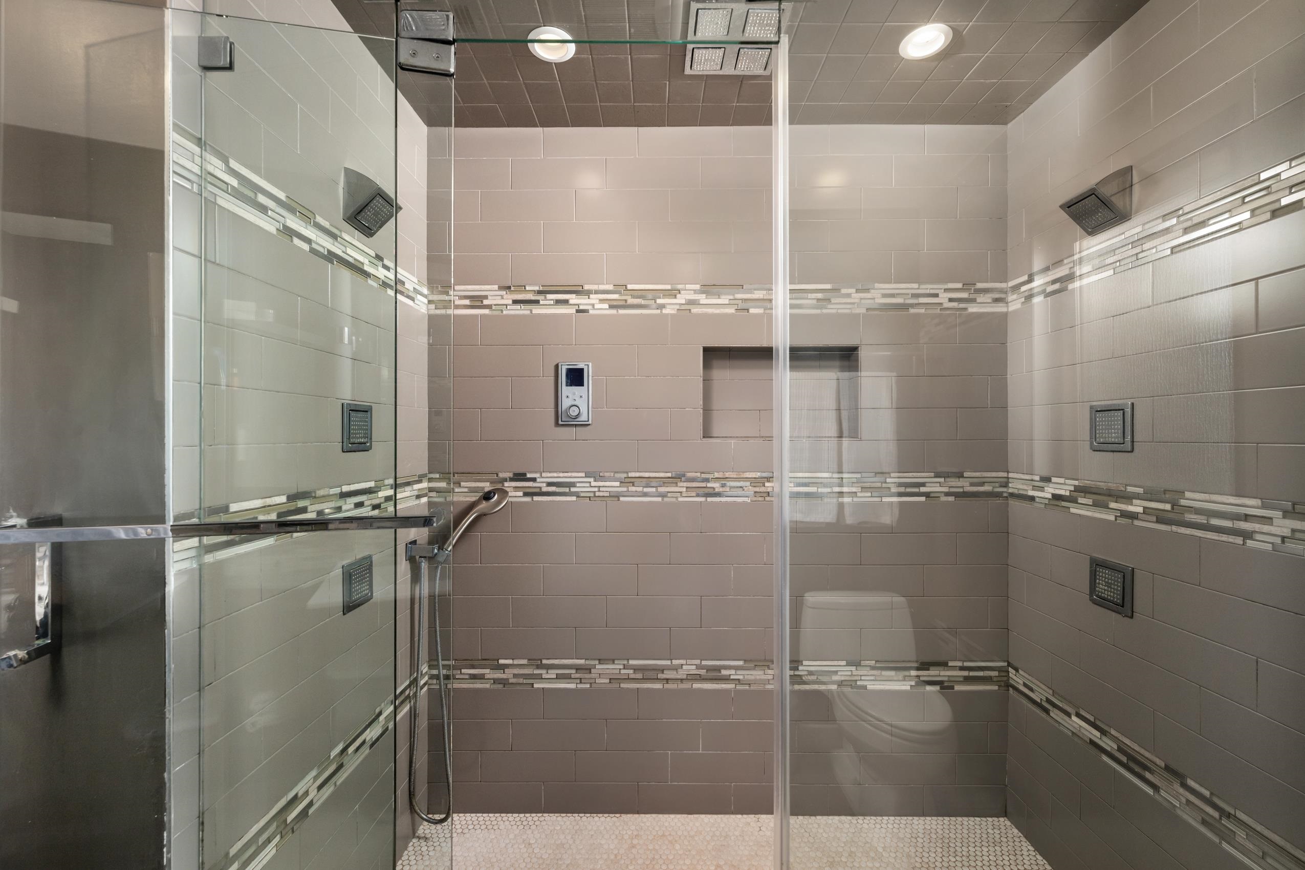 8805 Mountain Ridge Drive Austin, TX 78759 - Photo 18 of 30 a bathroom with a glass shower door