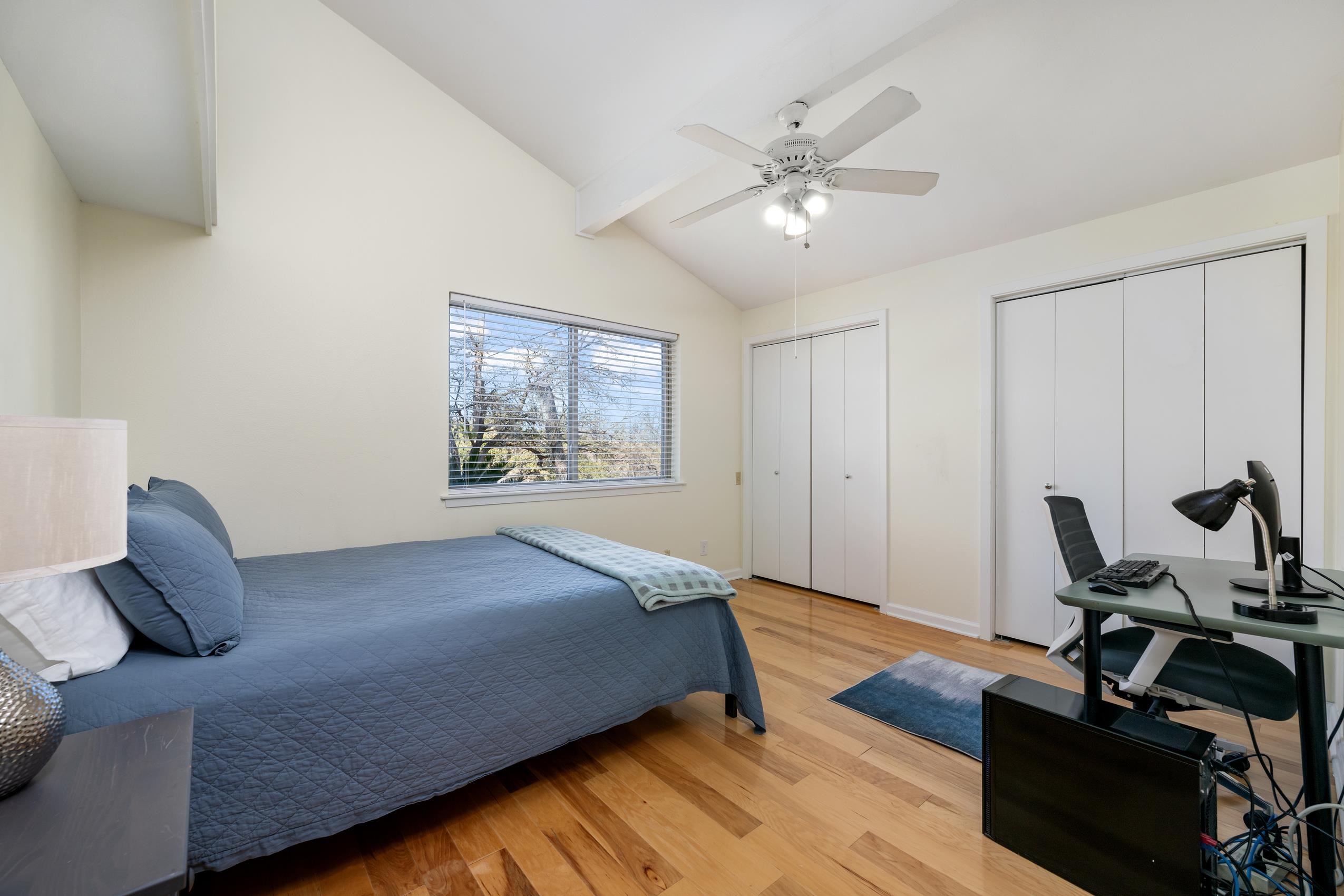 8805 Mountain Ridge Drive Austin, TX 78759 - Photo 19 of 30 a bedroom with a bed and wooden floor