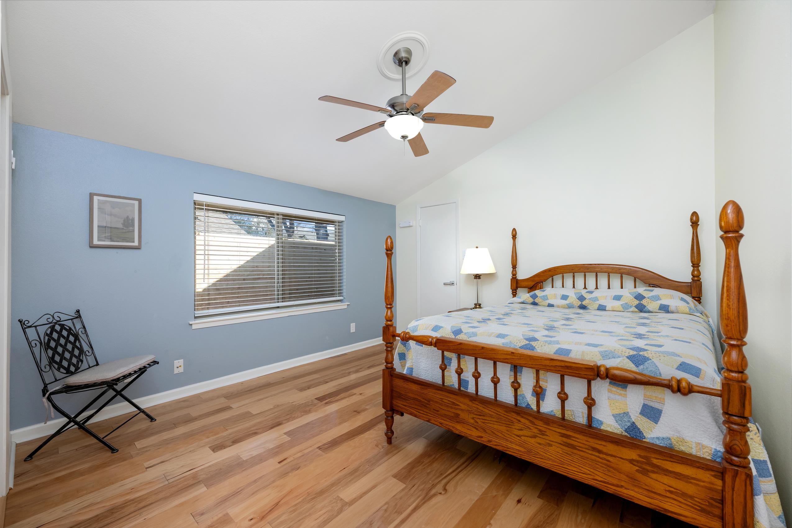 8805 Mountain Ridge Drive Austin, TX 78759 - Photo 21 of 30 a bedroom with a bed and wooden floor