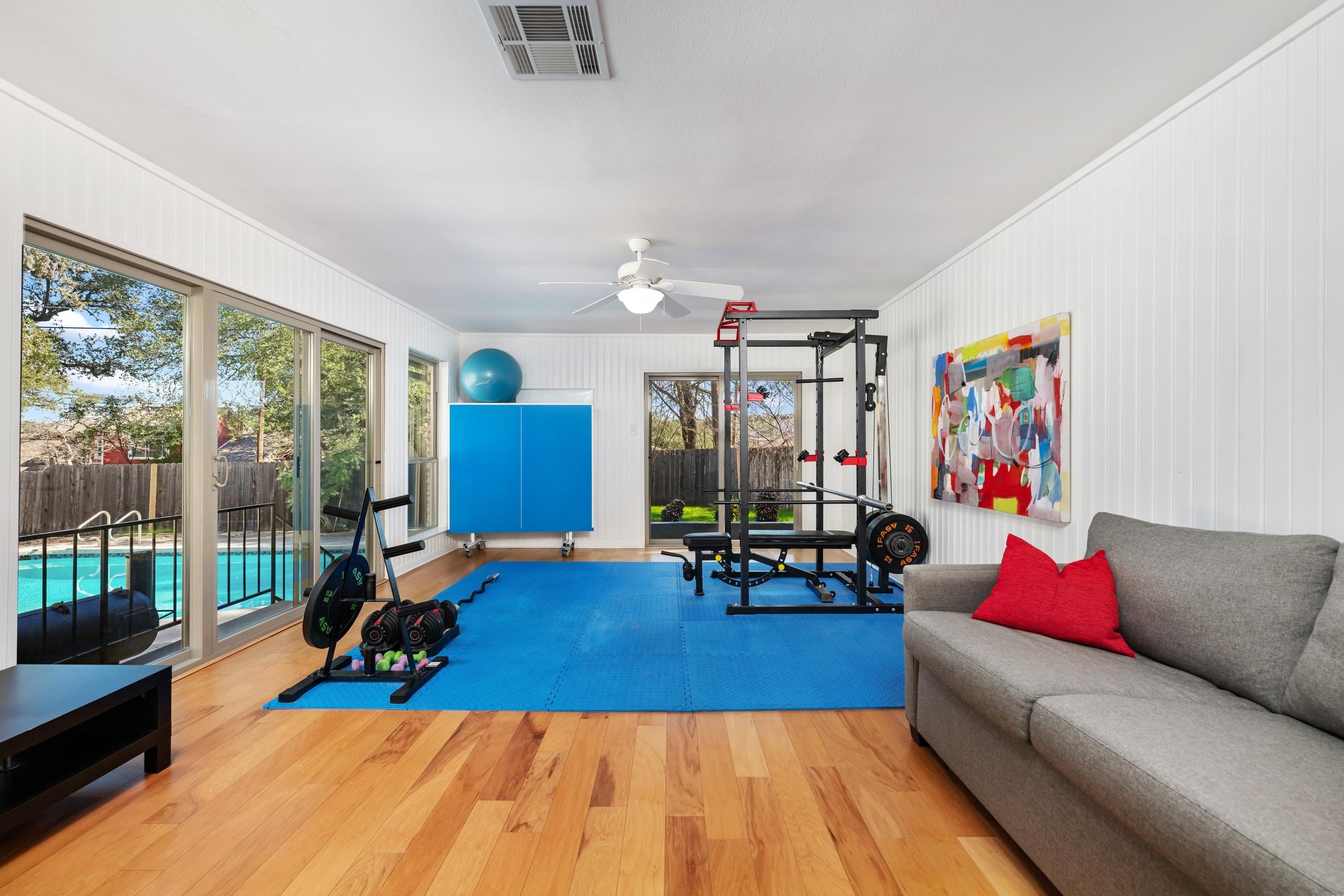 8805 Mountain Ridge Drive Austin, TX 78759 - Photo 24 of 30 a living room with furniture and a wooden floor