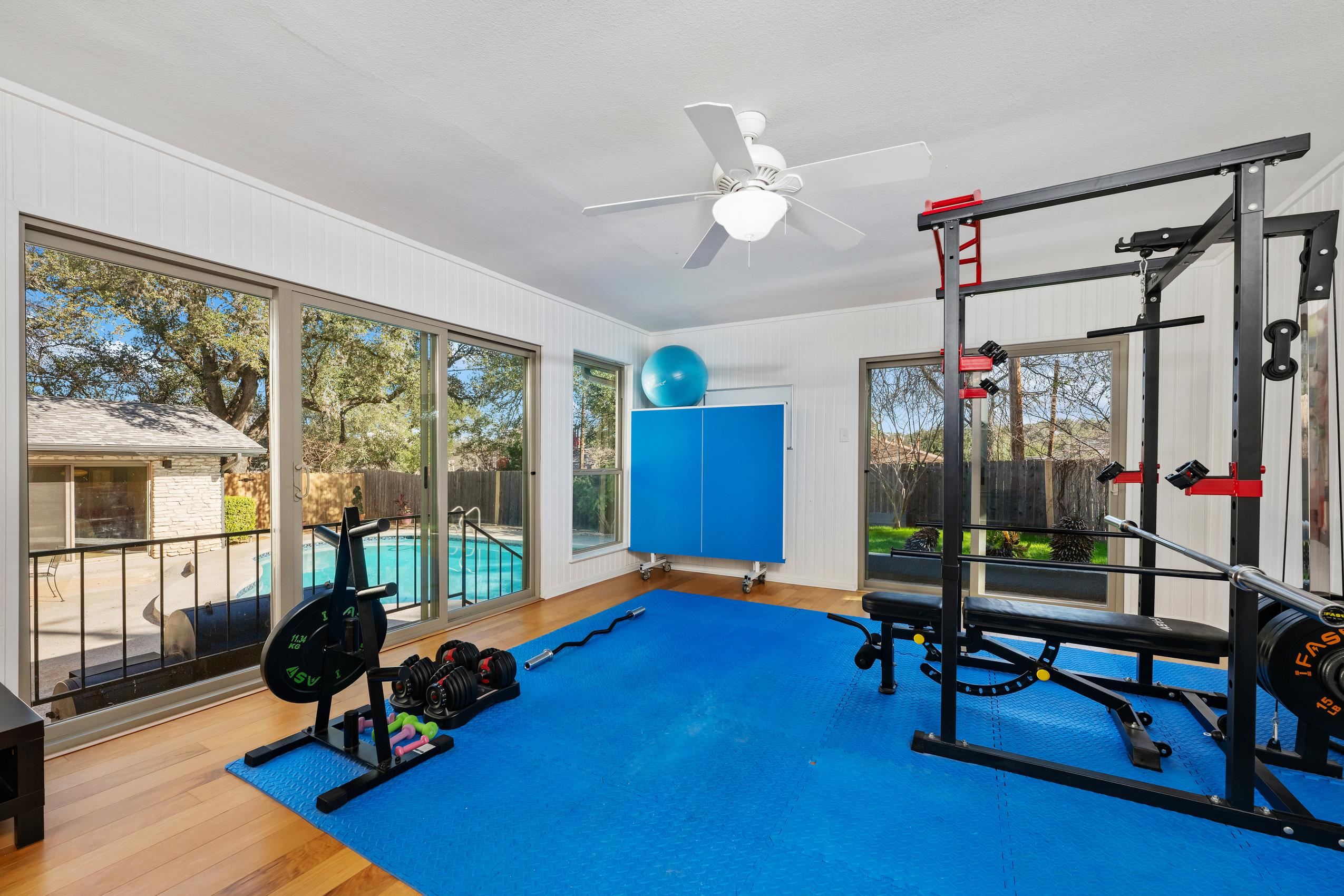 8805 Mountain Ridge Drive Austin, TX 78759 - Photo 25 of 30 a view of game room with gym equipment and a large window