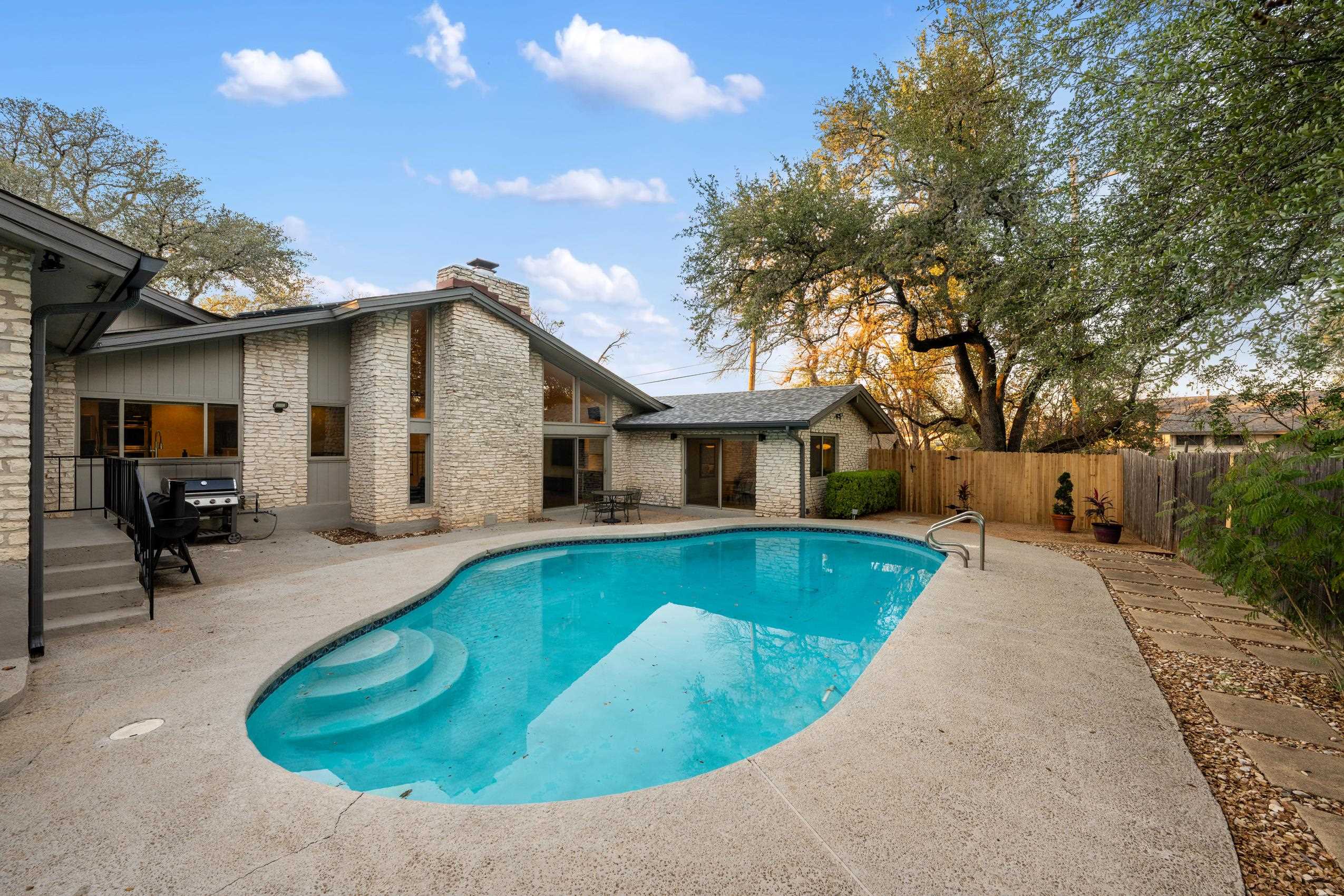 8805 Mountain Ridge Drive Austin, TX 78759 - Photo 26 of 30 a view of a house with pool