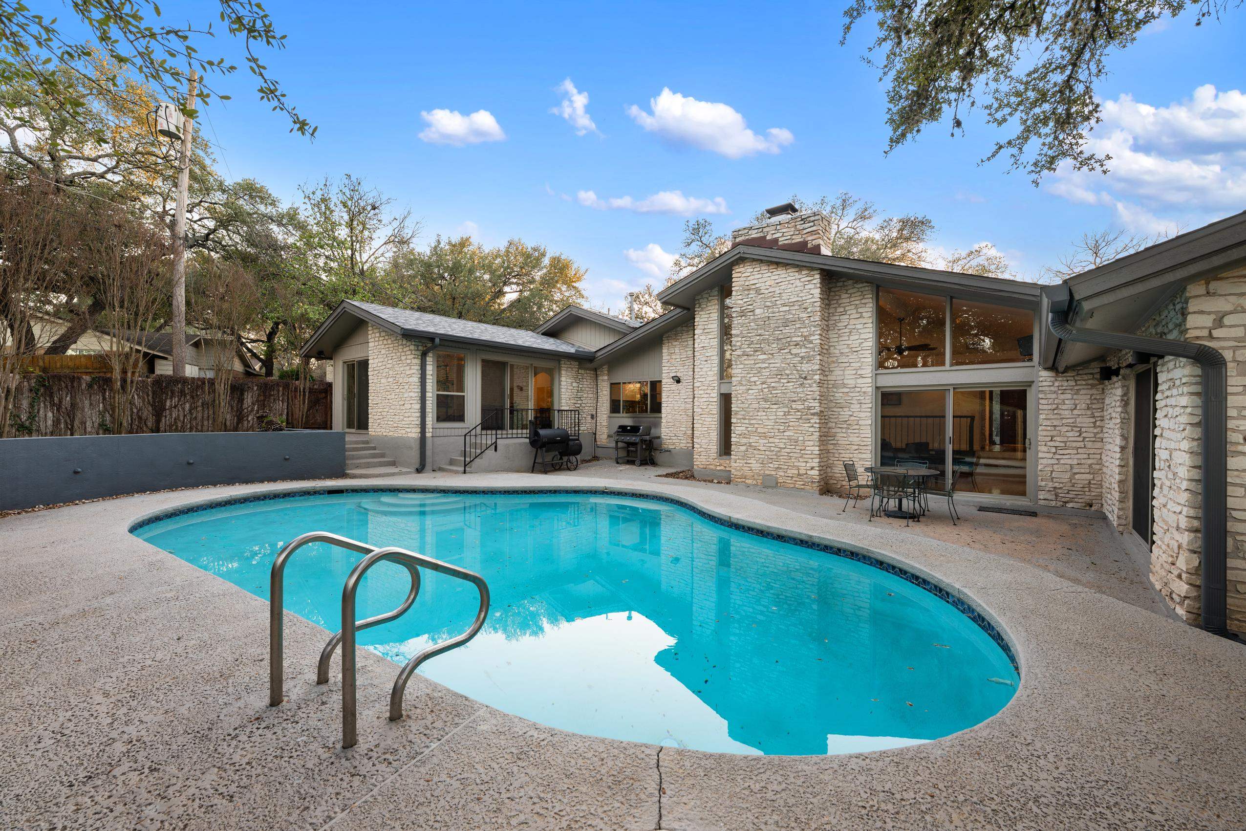 8805 Mountain Ridge Drive Austin, TX 78759 - Photo 27 of 30 a view of a house with swimming pool and sitting area
