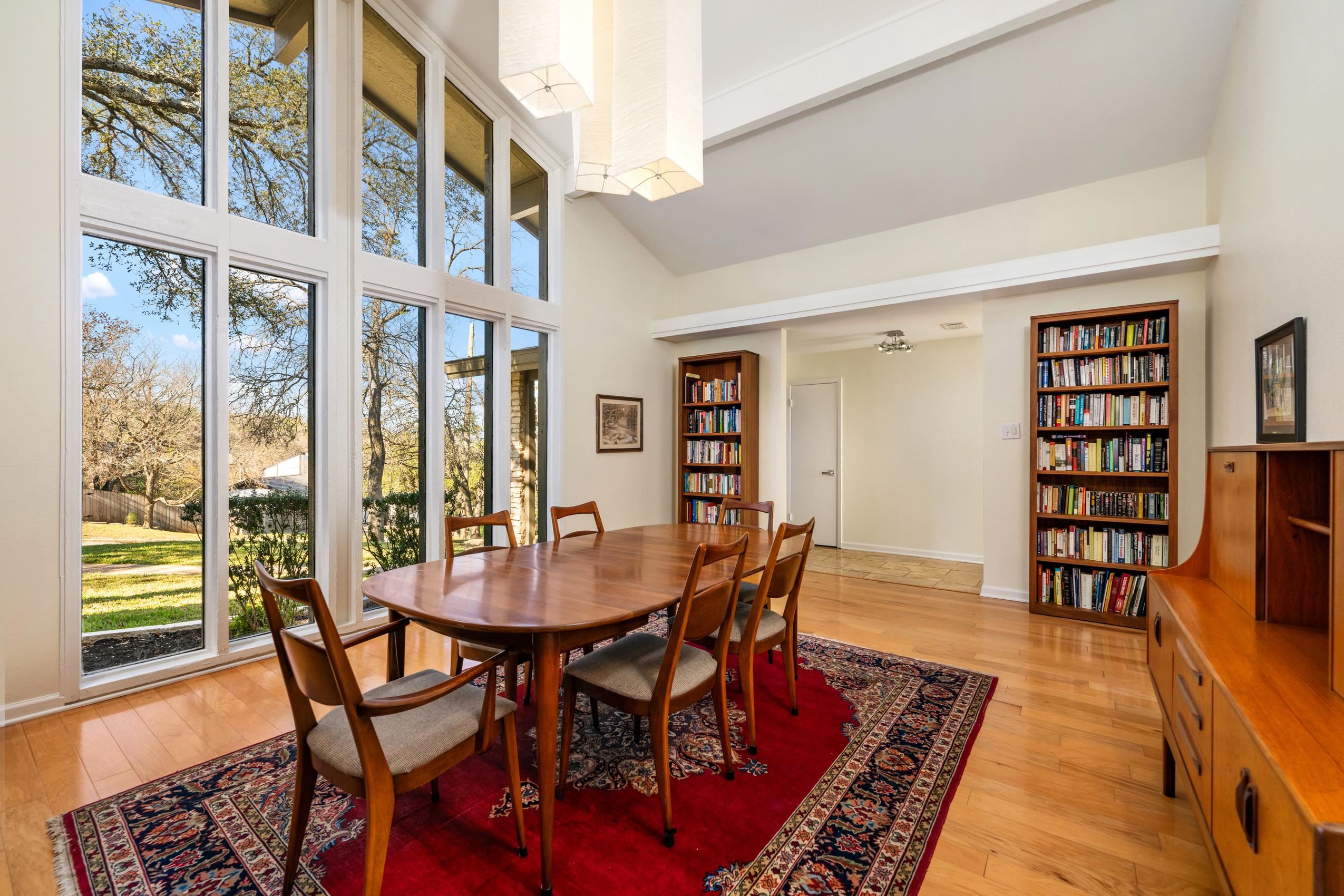 8805 Mountain Ridge Drive Austin, TX 78759 - Photo 4 of 30 a view of a dining room with furniture and a wooden floor