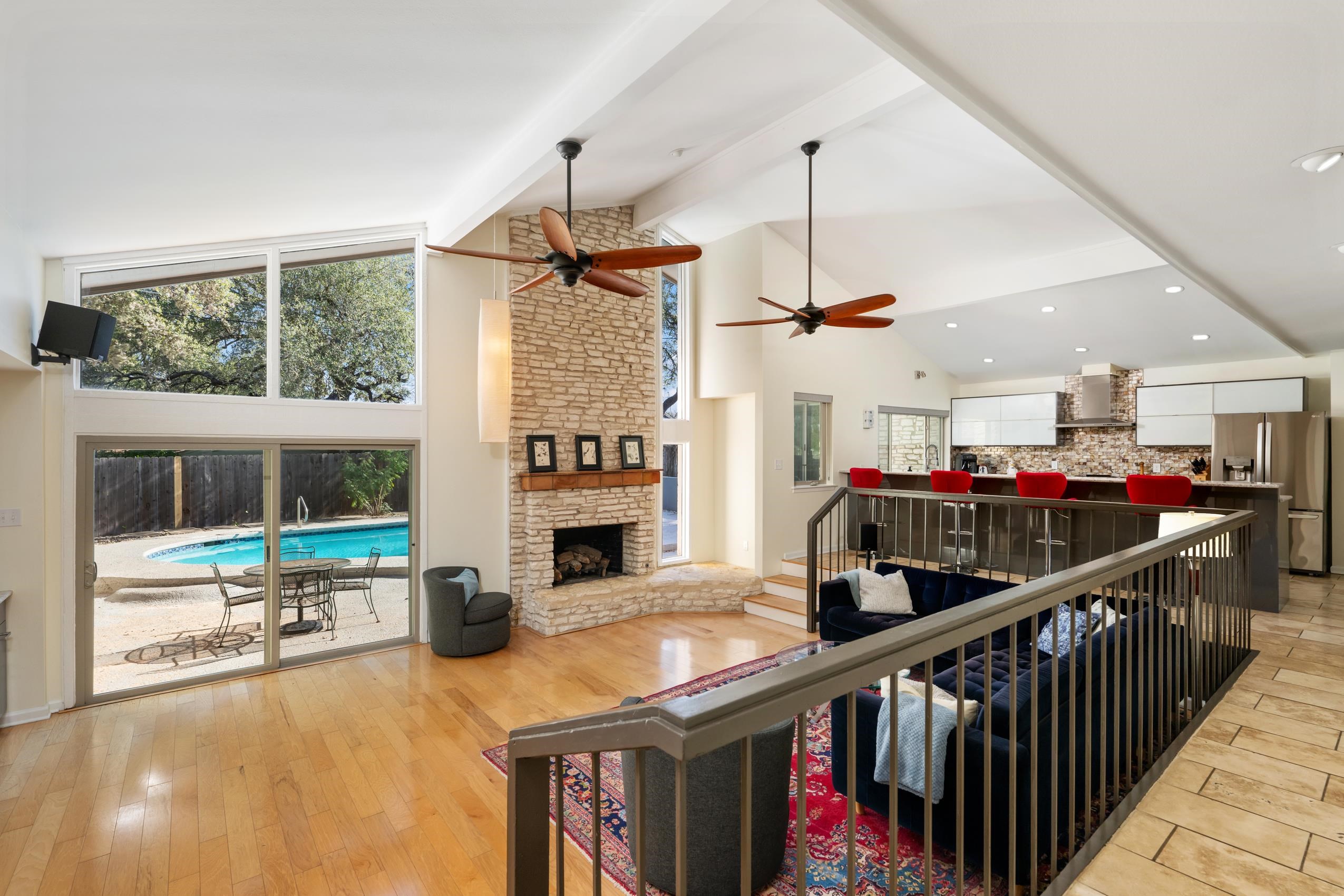 8805 Mountain Ridge Drive Austin, TX 78759 - Photo 7 of 30 a view of a hallway with fireplace and dining room