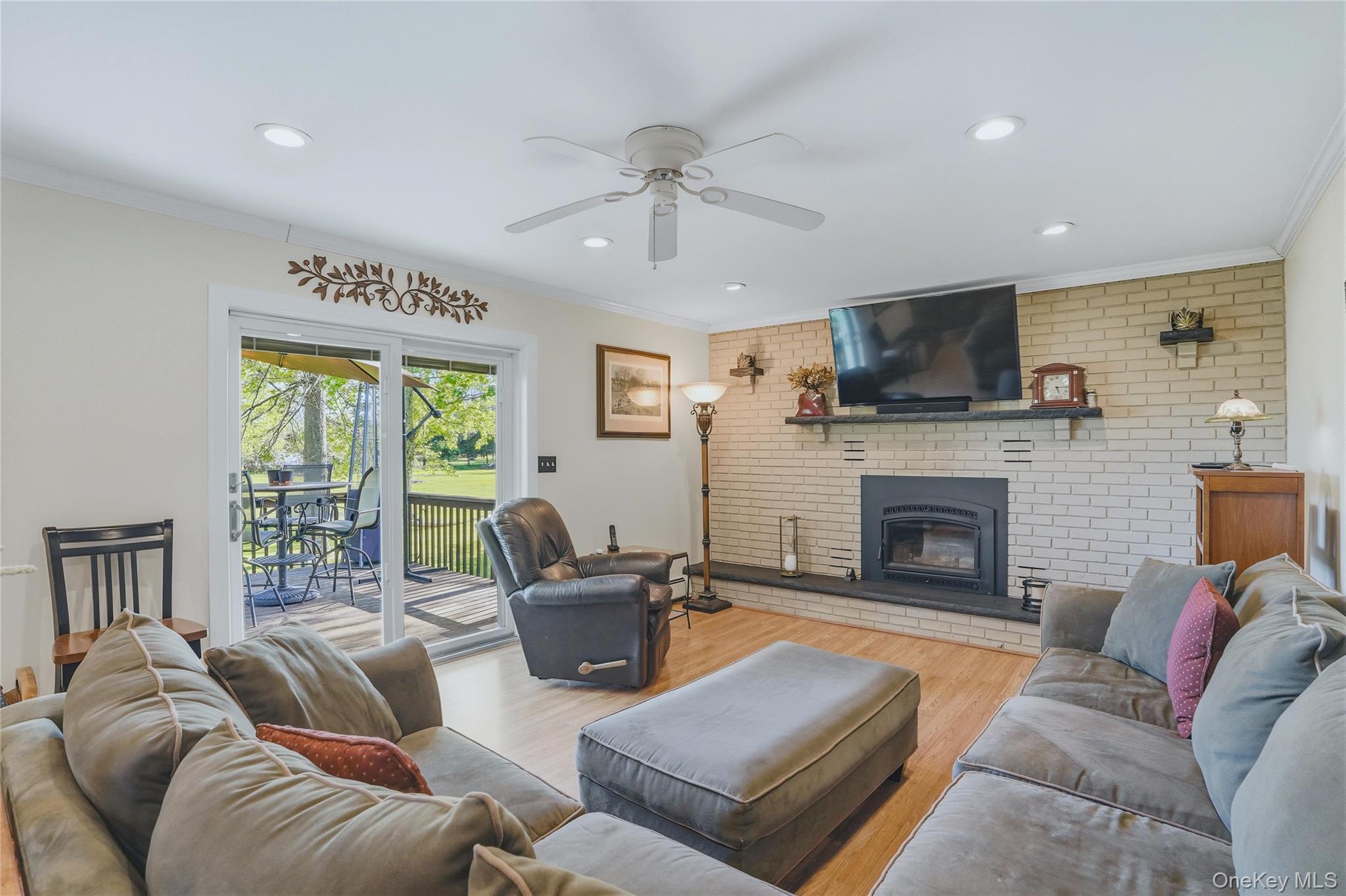 36 River Glen Road Wallkill, NY 12589 - Photo 15 of 47 a living room with furniture a fireplace and a flat screen tv