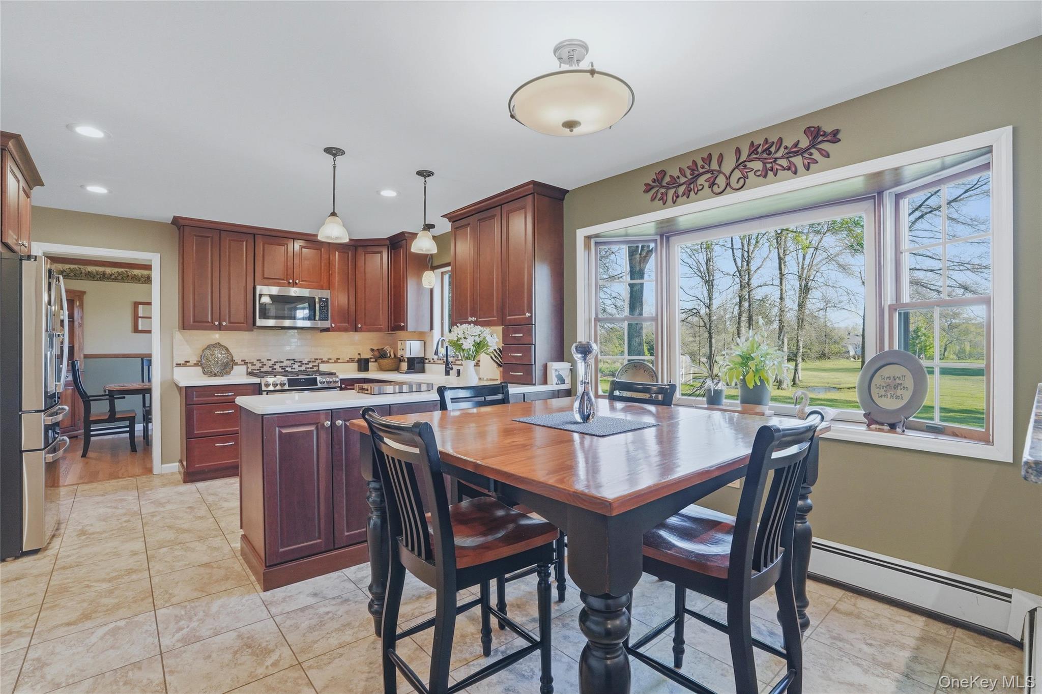 36 River Glen Road Wallkill, NY 12589 - Photo 6 of 47 a dining table with kitchen island granite countertop furniture and a large window