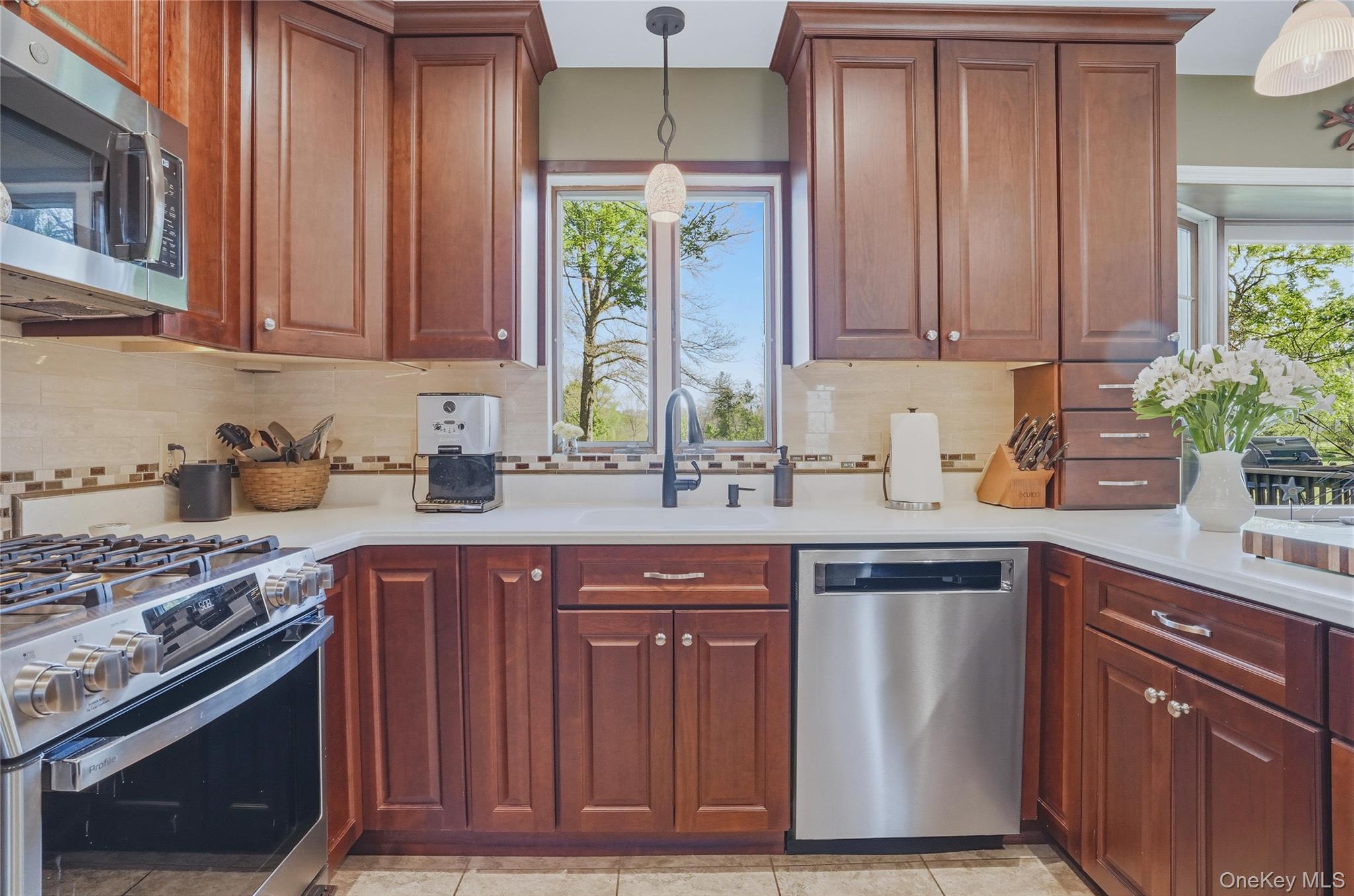 36 River Glen Road Wallkill, NY 12589 - Photo 8 of 47 a kitchen with stainless steel appliances granite countertop wooden cabinets a sink and a stove