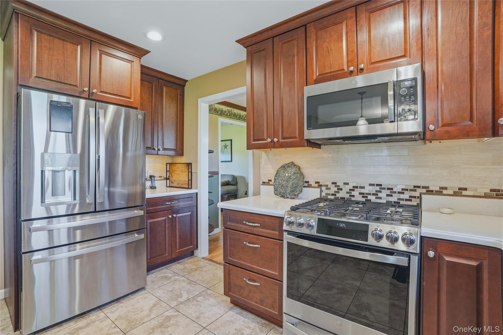 36 River Glen Road Wallkill, NY 12589 - Photo 10 of 47 a kitchen with stainless steel appliances granite countertop a stove microwave and refrigerator