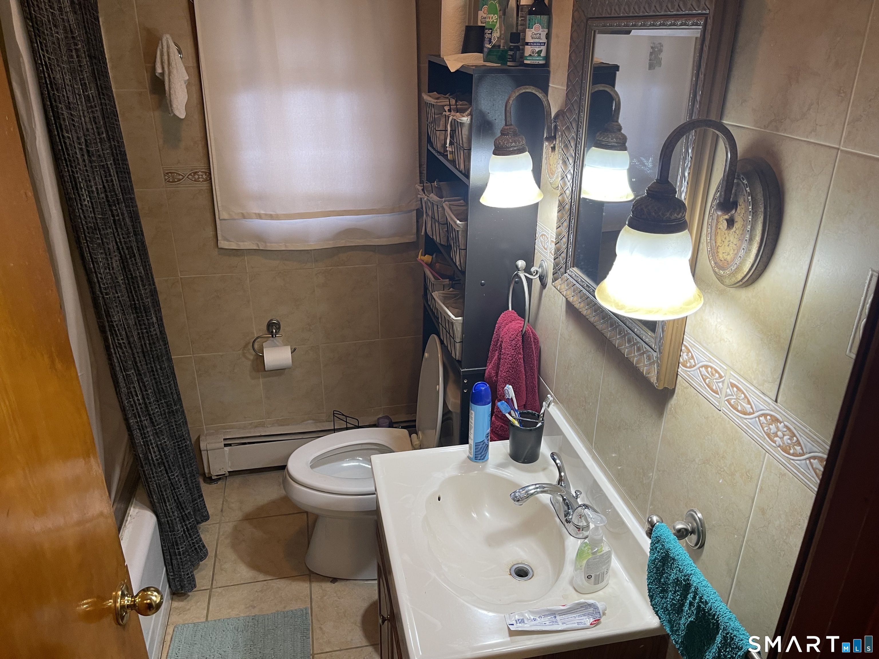 52 Bennett Avenue Waterbury, CT 06708 - Photo 11 of 36 a bathroom with a toilet sink and mirror