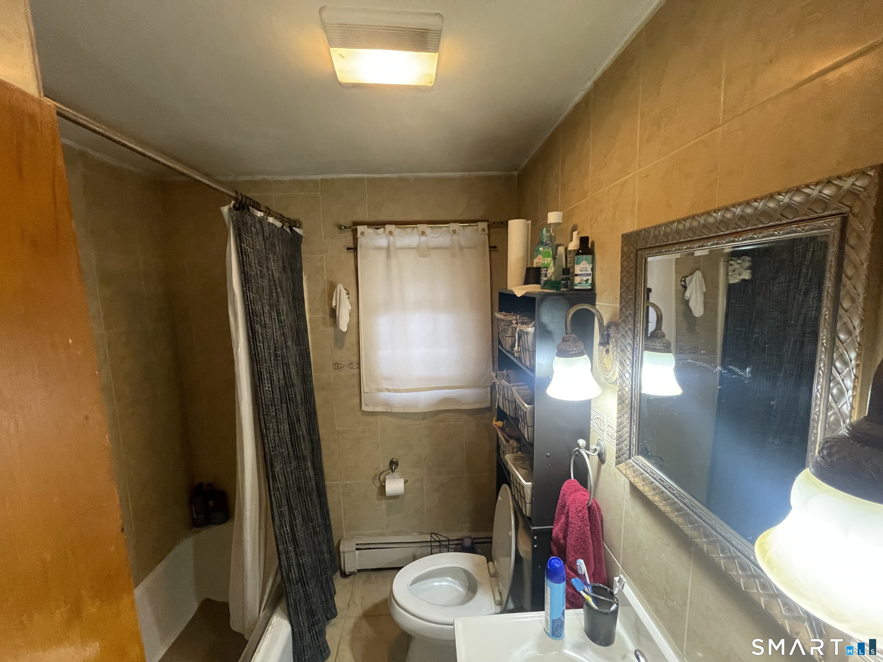 52 Bennett Avenue Waterbury, CT 06708 - Photo 12 of 36 a bathroom with a mirror and a shower