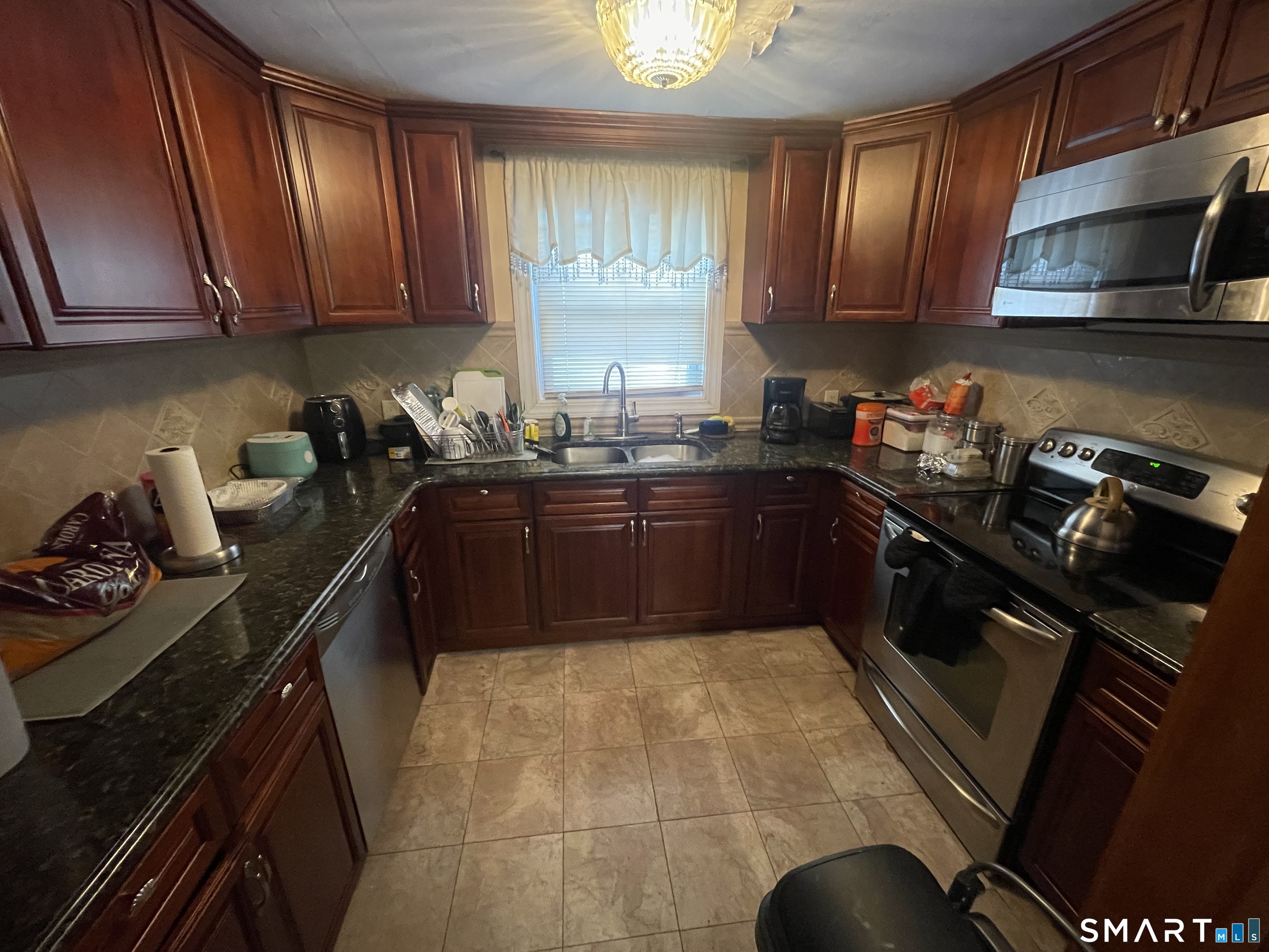 52 Bennett Avenue Waterbury, CT 06708 - Photo 18 of 36 a kitchen with a sink stove and cabinets