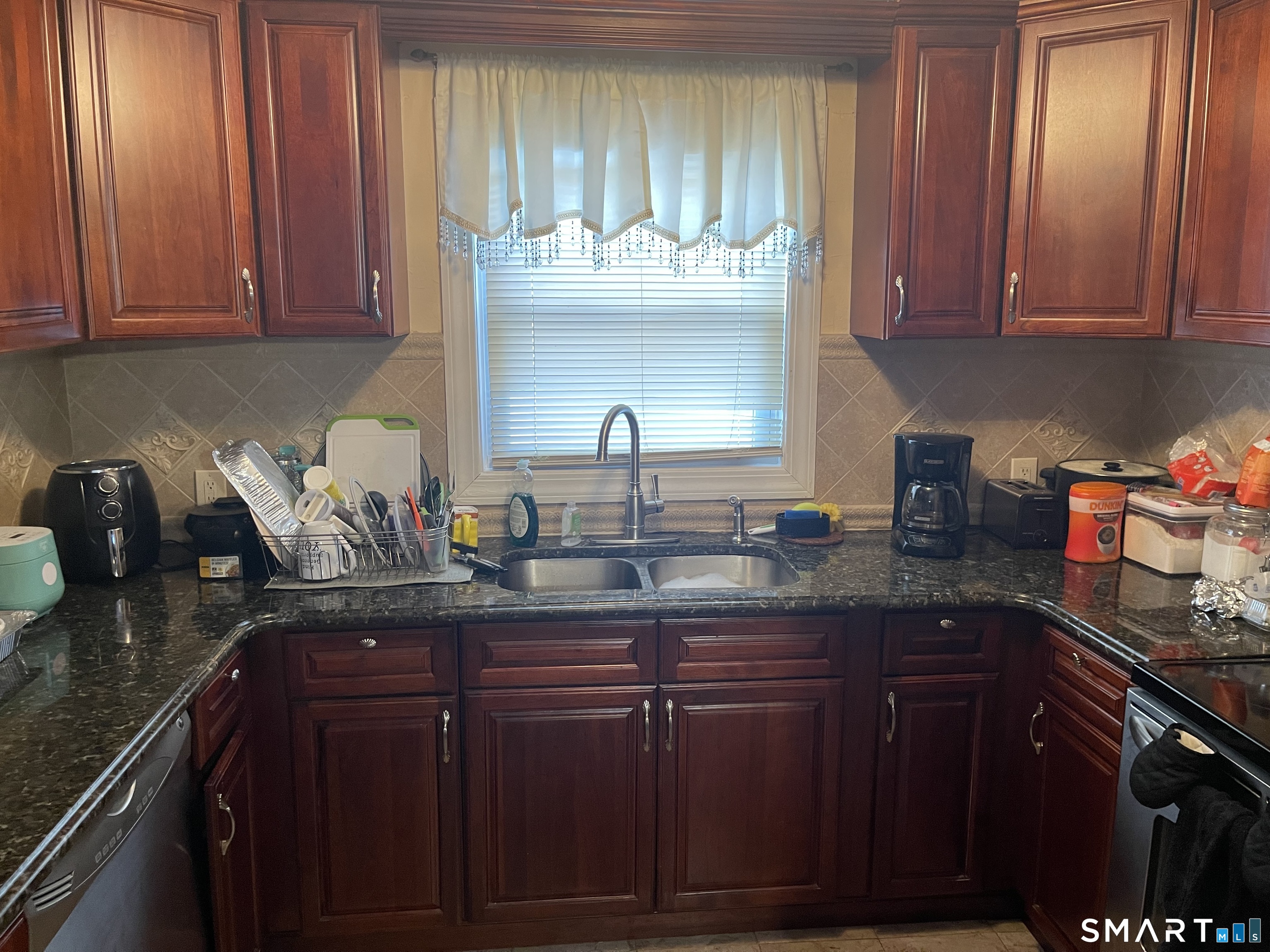 52 Bennett Avenue Waterbury, CT 06708 - Photo 19 of 36 a kitchen with granite countertop a sink stainless steel appliances and cabinets