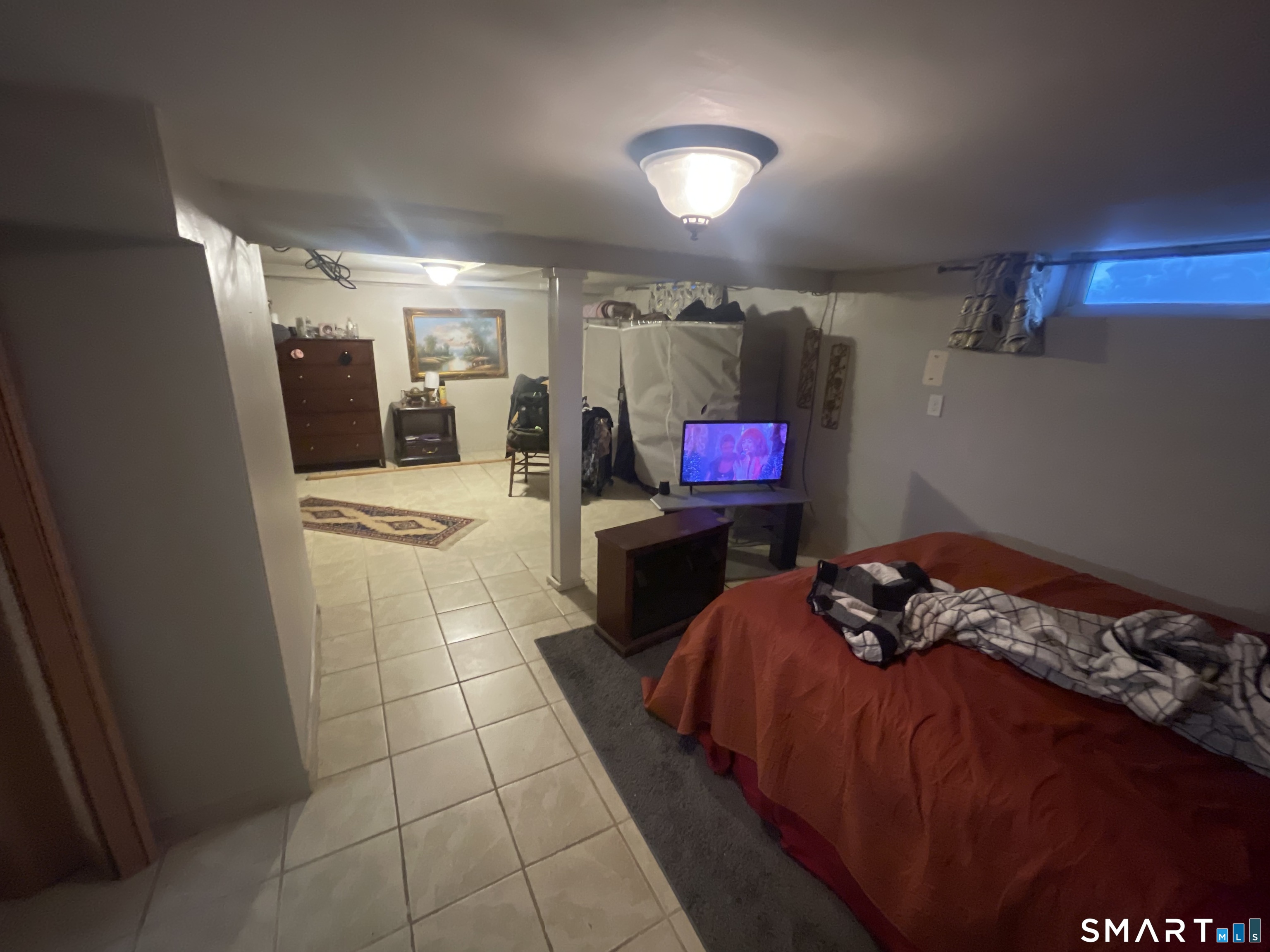 52 Bennett Avenue Waterbury, CT 06708 - Photo 30 of 36 a bed room with a bed and a television