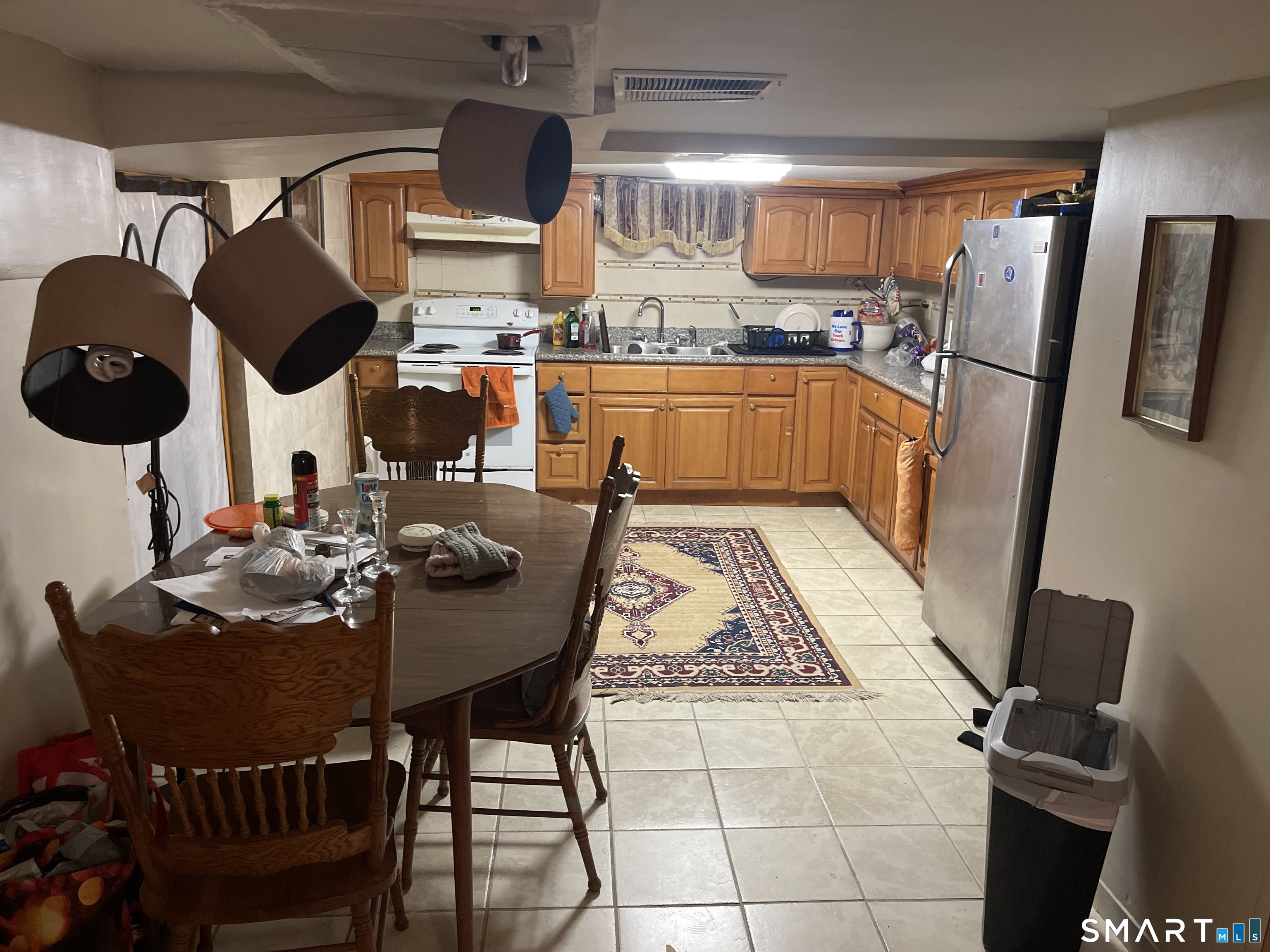 52 Bennett Avenue Waterbury, CT 06708 - Photo 31 of 36 a kitchen with a sink a stove and chairs