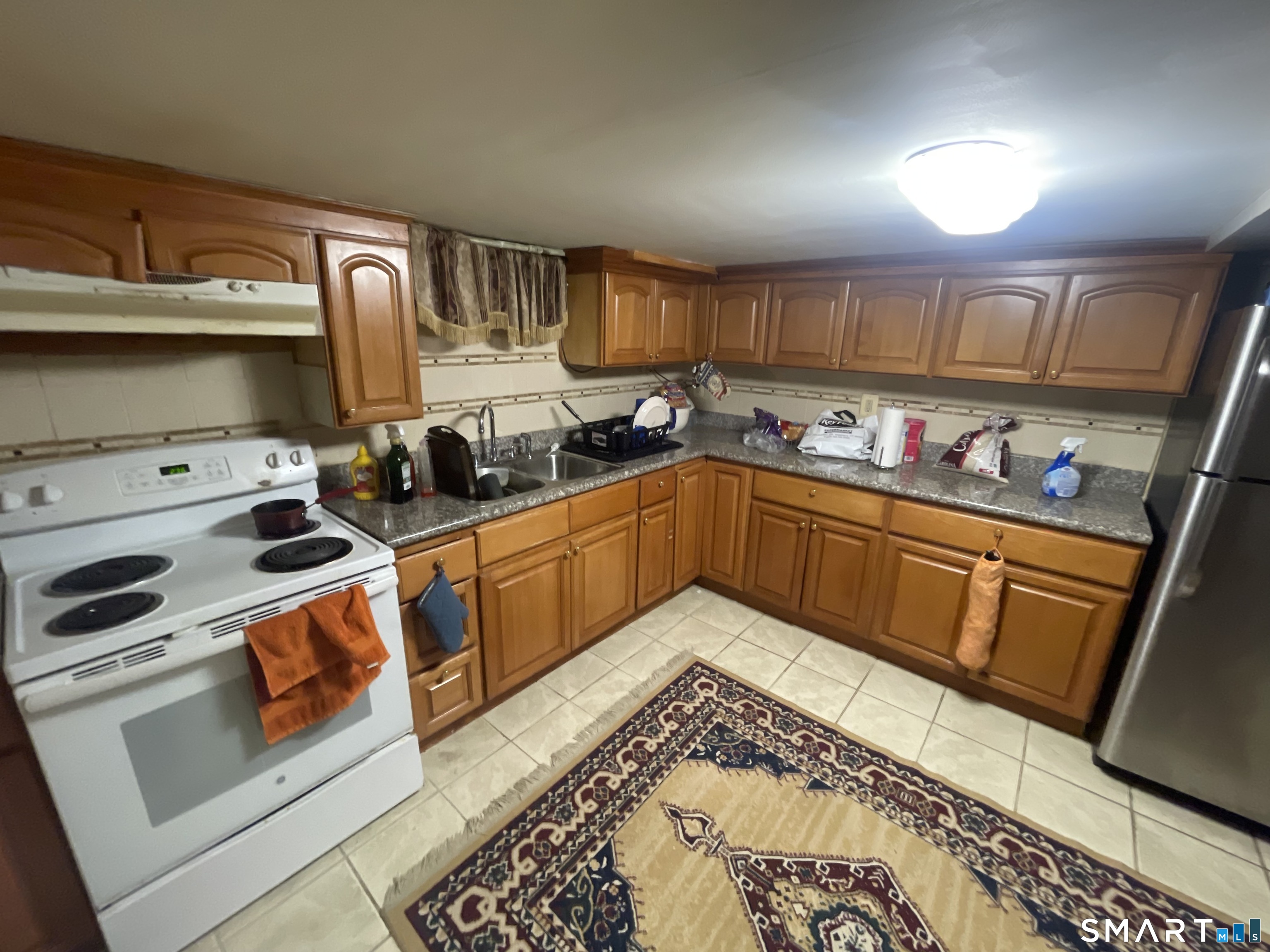 52 Bennett Avenue Waterbury, CT 06708 - Photo 32 of 36 a kitchen with stainless steel appliances a stove a sink and a refrigerator
