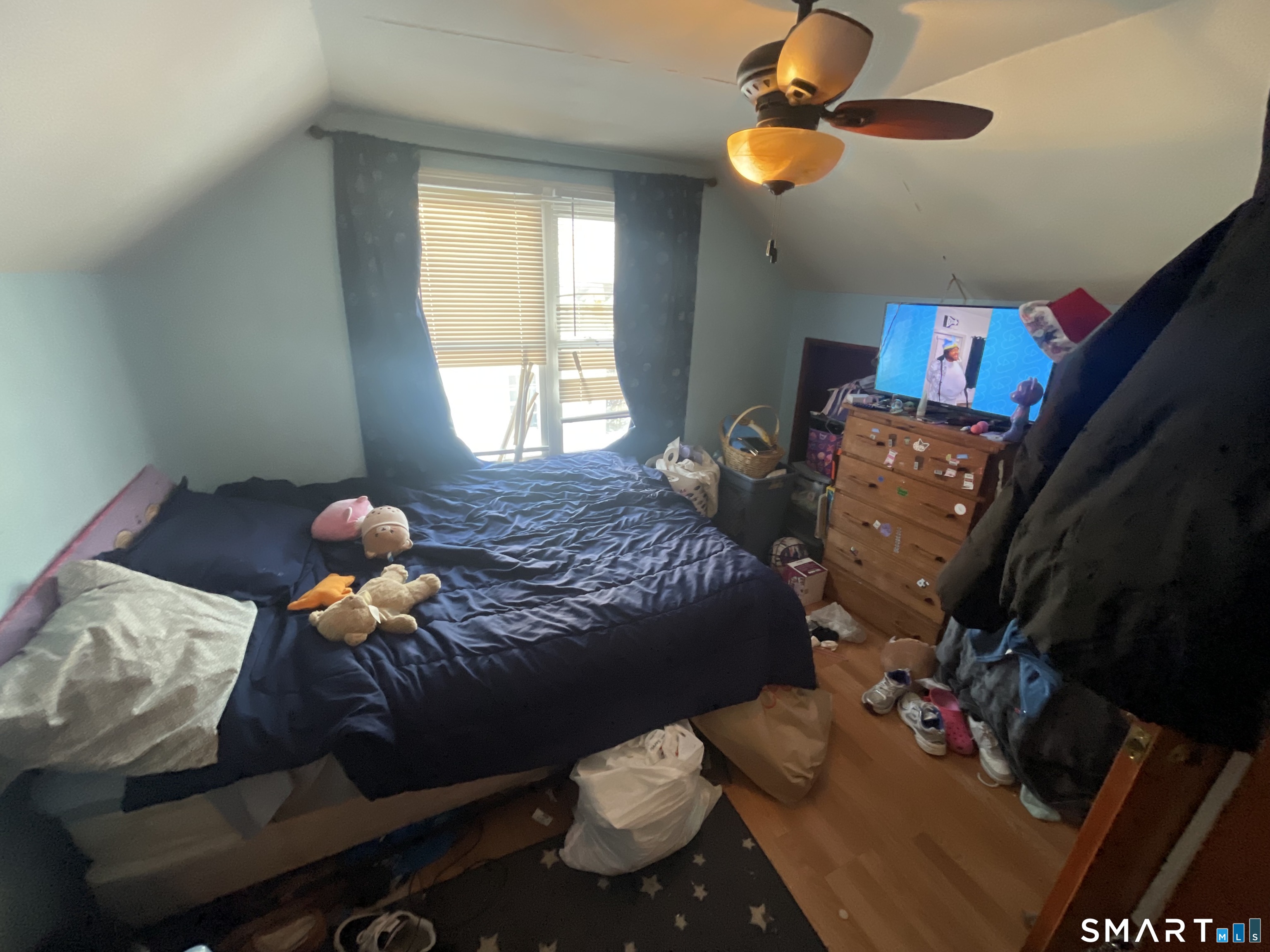 52 Bennett Avenue Waterbury, CT 06708 - Photo 36 of 36 a bedroom with a bed and a chandelier