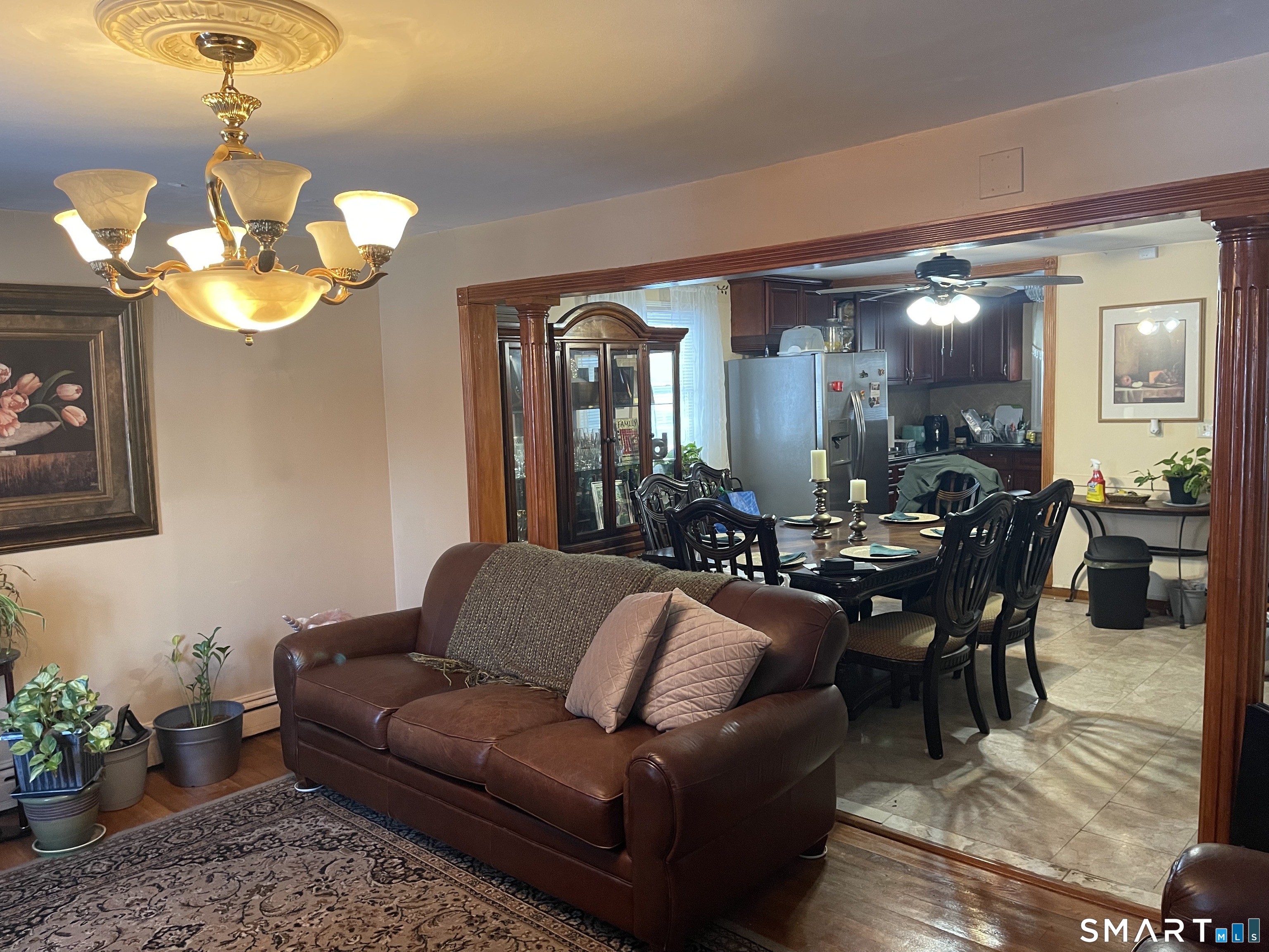52 Bennett Avenue Waterbury, CT 06708 - Photo 7 of 36 a living room with furniture a chandelier and a mirror