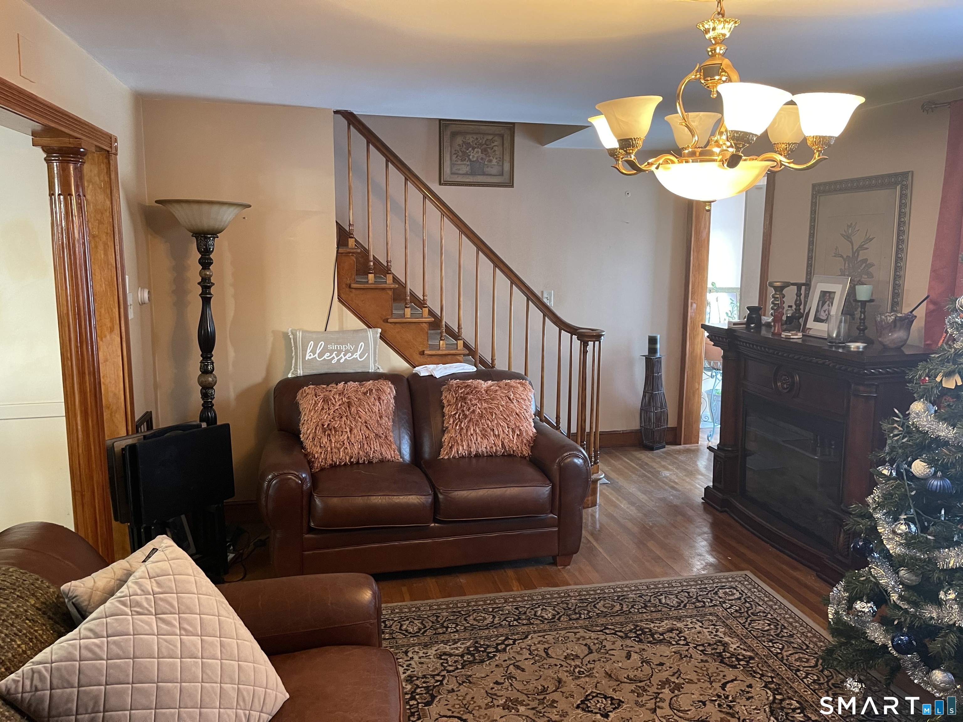52 Bennett Avenue Waterbury, CT 06708 - Photo 9 of 36 a living room with furniture and a chandelier