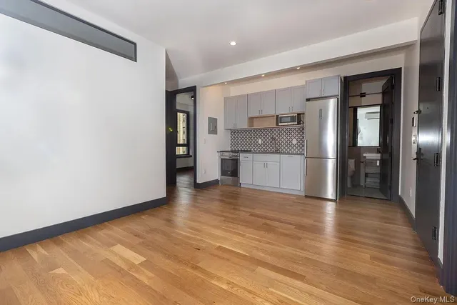 a view of a kitchen with a sink and a refrigerator