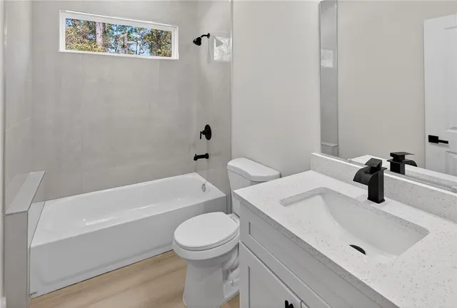 a bathroom with a sink a toilet and bathtub