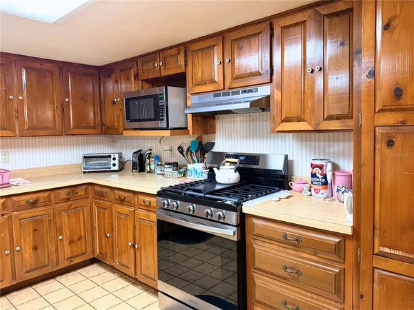 a kitchen with stainless steel appliances granite countertop a stove and cabinets