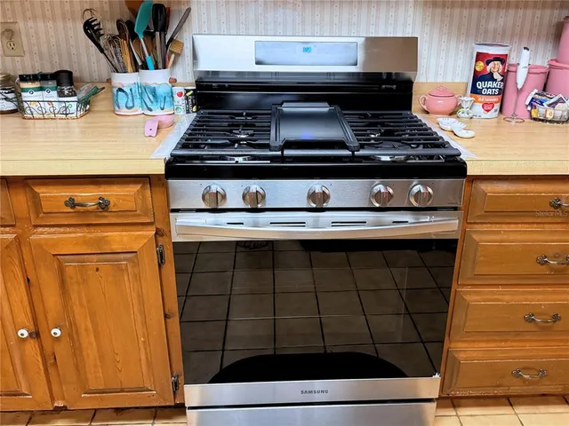 a stove top oven sitting inside of a kitchen