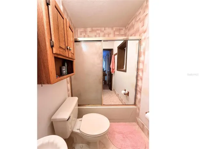 a white toilet sitting next to a bathroom sink